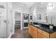 Modern bathroom featuring granite countertops, wood cabinetry, glass shower, custom closet, and stacked laundry at 1029 Piedmont Ne Ave # 102, Atlanta, GA 30309