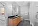 Bright bathroom featuring granite countertops, wood cabinetry, glass shower, and neutral color palette at 1029 Piedmont Ne Ave # 102, Atlanta, GA 30309