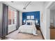 Serene bedroom featuring a blue accent wall, neutral decor, and soft natural light, creating a relaxing retreat at 1029 Piedmont Ne Ave # 102, Atlanta, GA 30309