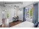 Bright, modern bedroom with hardwood floors, light walls, large windows and a view of the city skyline at 1029 Piedmont Ne Ave # 102, Atlanta, GA 30309