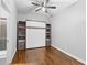 Bright bedroom featuring hardwood floors, a modern ceiling fan and a murphy bed with built-in storage at 1029 Piedmont Ne Ave # 102, Atlanta, GA 30309