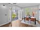 Bright dining area with hardwood floors, seating for four, and access to a private balcony with outdoor seating at 1029 Piedmont Ne Ave # 102, Atlanta, GA 30309