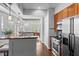 Modern kitchen has breakfast bar seating and stainless steel appliances at 1029 Piedmont Ne Ave # 102, Atlanta, GA 30309