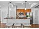 Open kitchen offers a breakfast bar with three stools and modern lighting at 1029 Piedmont Ne Ave # 102, Atlanta, GA 30309