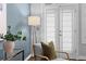 Bright sitting area with modern chair, lamp, and french doors to outdoor space at 1029 Piedmont Ne Ave # 102, Atlanta, GA 30309