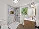 Bathroom with marble tiled shower, a gold faucet and a round mirror at 1282 Eastridge Sw Rd, Atlanta, GA 30311