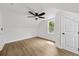 Bedroom featuring wood flooring, white walls, a ceiling fan, and a window at 1282 Eastridge Sw Rd, Atlanta, GA 30311