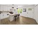 Contemporary kitchen with white cabinets, center island with barstool seating, and stylish fixtures at 1282 Eastridge Sw Rd, Atlanta, GA 30311
