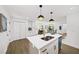 Bright open kitchen features a large island, stainless appliances, and stylish pendant lighting at 1282 Eastridge Sw Rd, Atlanta, GA 30311