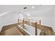 Loft featuring wood flooring and white walls with modern railings at 1282 Eastridge Sw Rd, Atlanta, GA 30311