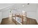 Bright loft area with wood flooring and a modern railing at 1282 Eastridge Sw Rd, Atlanta, GA 30311