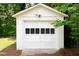 Close-up of the white storage shed with a garage-style door at 1282 Eastridge Sw Rd, Atlanta, GA 30311
