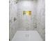 New stylish tiled shower with a sleek glass enclosure and gold fixtures at 1282 Eastridge Sw Rd, Atlanta, GA 30311