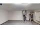 Unfinished basement with equipment, door to outside, and concrete flooring at 2740 Ashley Downs Ln, Atlanta, GA 30349