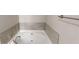 White bathtub featuring tile surround and updated fixtures at 2740 Ashley Downs Ln, Atlanta, GA 30349