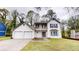Two-story home with a two-car garage, balcony, and manicured front lawn at 2740 Ashley Downs Ln, Atlanta, GA 30349