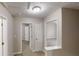 A neutral-toned hallway with carpet and white doors leading to various rooms at 2740 Ashley Downs Ln, Atlanta, GA 30349