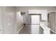 Galley kitchen features a stainless steel refrigerator and bright white cabinetry at 2740 Ashley Downs Ln, Atlanta, GA 30349
