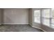Open living room with gray tile flooring and large windows at 2740 Ashley Downs Ln, Atlanta, GA 30349