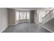 Living room area with tile flooring, large windows, and staircase at 2740 Ashley Downs Ln, Atlanta, GA 30349