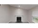 View of living room showing the fireplace, wood-look tile flooring, and natural lighting at 2740 Ashley Downs Ln, Atlanta, GA 30349