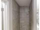 Shower stall tiled with neutral stone-look tile and modern shower head at 2740 Ashley Downs Ln, Atlanta, GA 30349