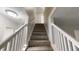Carpeted staircase with white painted railing at 2740 Ashley Downs Ln, Atlanta, GA 30349