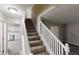 Carpeted staircase featuring a white railing leading to the upper level at 2740 Ashley Downs Ln, Atlanta, GA 30349