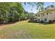 Expansive backyard featuring mature trees and lush greenery, ideal for recreation and relaxation at 3925 Waterford Dr, Suwanee, GA 30024