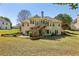 Picturesque backyard with a spacious lawn, mature trees, and multi-level deck at 3925 Waterford Dr, Suwanee, GA 30024
