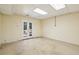 Unfinished basement with concrete flooring and double doors leading to the backyard at 3925 Waterford Dr, Suwanee, GA 30024