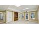 Large finished basement with neutral carpeting, built-in shelves, and a door to the outside at 3925 Waterford Dr, Suwanee, GA 30024