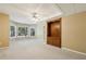Finished basement area with bright windows, neutral carpeting, and a built-in wooden display case at 3925 Waterford Dr, Suwanee, GA 30024