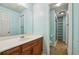 Bathroom featuring a single vanity and a walk-in shower with glass doors and built-in shelves at 3925 Waterford Dr, Suwanee, GA 30024