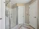 Bathroom features a glass-enclosed shower with tiled walls and floors, plus modern fixtures at 3925 Waterford Dr, Suwanee, GA 30024