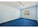 Bedroom featuring a light-blue painted walls, natural lighting and plush blue carpet at 3925 Waterford Dr, Suwanee, GA 30024