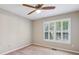 Cozy bedroom with a ceiling fan, carpet flooring, and natural light from a window at 3925 Waterford Dr, Suwanee, GA 30024