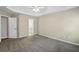 Large primary bedroom features a tray ceiling, carpet flooring, and access to the en suite bathroom at 3925 Waterford Dr, Suwanee, GA 30024