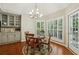 Bright breakfast nook features a chandelier, hardwood floors, and natural light from many windows at 3925 Waterford Dr, Suwanee, GA 30024