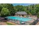 Well-maintained community pool with ample seating, a clubhouse, and lush greenery at 3925 Waterford Dr, Suwanee, GA 30024