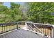 Back deck overlooking a large yard with views of mature trees at 3925 Waterford Dr, Suwanee, GA 30024