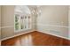 Light-filled dining room with hardwood floors, a chandelier, and a large arched window at 3925 Waterford Dr, Suwanee, GA 30024
