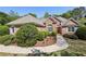 Beautifully landscaped brick home with a curved walkway, lush green bushes, and an arched window feature at 3925 Waterford Dr, Suwanee, GA 30024