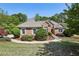 Charming single-story brick home featuring manicured landscaping, a curved walkway, and a well-maintained lawn at 3925 Waterford Dr, Suwanee, GA 30024