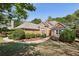Charming brick home with manicured landscaping, arched window, and inviting entryway at 3925 Waterford Dr, Suwanee, GA 30024