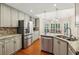Spacious kitchen boasts stainless steel appliances, granite countertops, and ample cabinet space at 3925 Waterford Dr, Suwanee, GA 30024