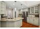 Bright kitchen with stainless steel appliances, granite countertops, and wood flooring at 3925 Waterford Dr, Suwanee, GA 30024