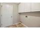 Laundry room with ample cabinet space and a door leading to the outside at 3925 Waterford Dr, Suwanee, GA 30024