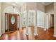 Open-concept living room featuring hardwood floors, decorative columns, and a view into the adjacent dining area at 3925 Waterford Dr, Suwanee, GA 30024
