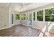 Bright sunroom with laminate wood flooring, multiple windows, ceiling fan and access to the deck at 3925 Waterford Dr, Suwanee, GA 30024